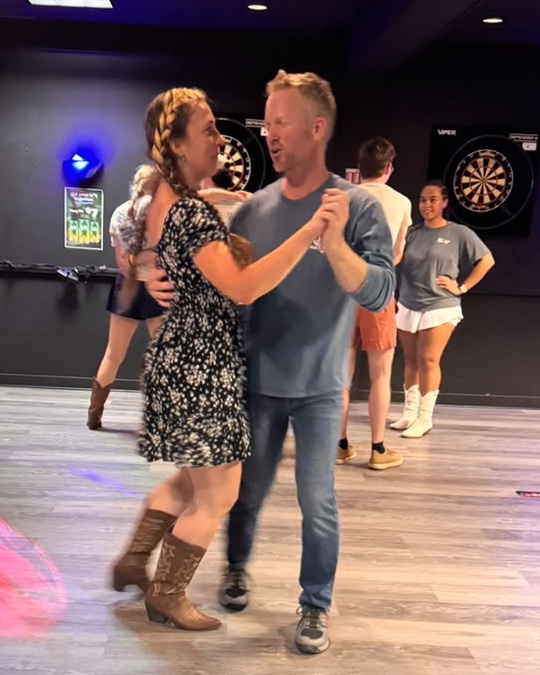 Couple country swing dancing at Rodeo Swing Maine in Portland